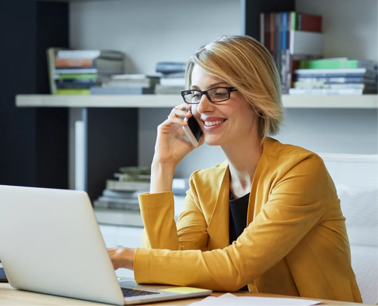 Person talking on the phone looking at computer